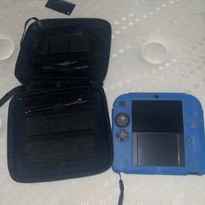 Blue 2ds, comes with blue grip case and a black case that holds games and 2ds